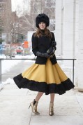 Karolina Gliniecka in an Aryton hat and jacket with a Louis Vuitton clutch
